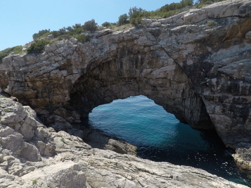 Magnificant ocean hole and cave seen from cliff along side of Uvala Pertusa on Otok Sipan, Croatia